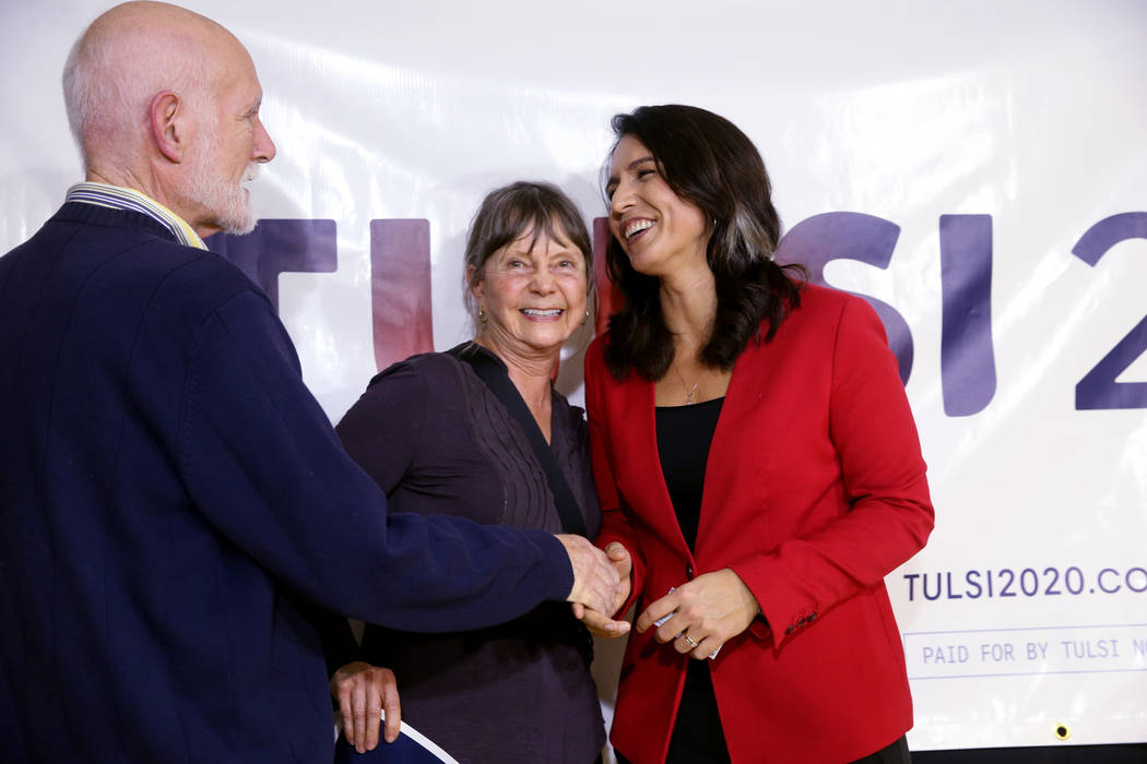 Presidential hopeful U.S. Rep. Tulsi Gabbard, D-Hawaii, right, with Paul and Melinda Douglas of North Las Vegas during a meet and greet at the Asian Culture Center in downtown Las Vegas Monday, Ma ...