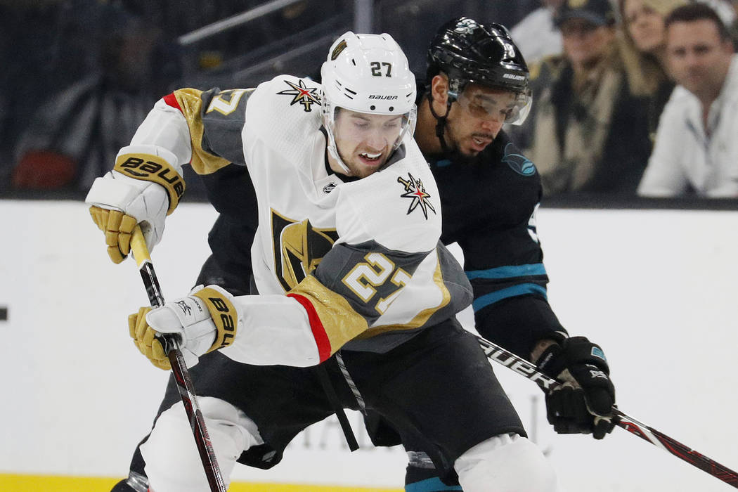 Vegas Golden Knights defenseman Shea Theodore (27) skates around San Jose Sharks left wing Evander Kane during the first period of an NHL hockey game Thursday, Jan. 10, 2019, in Las Vegas. (AP Pho ...