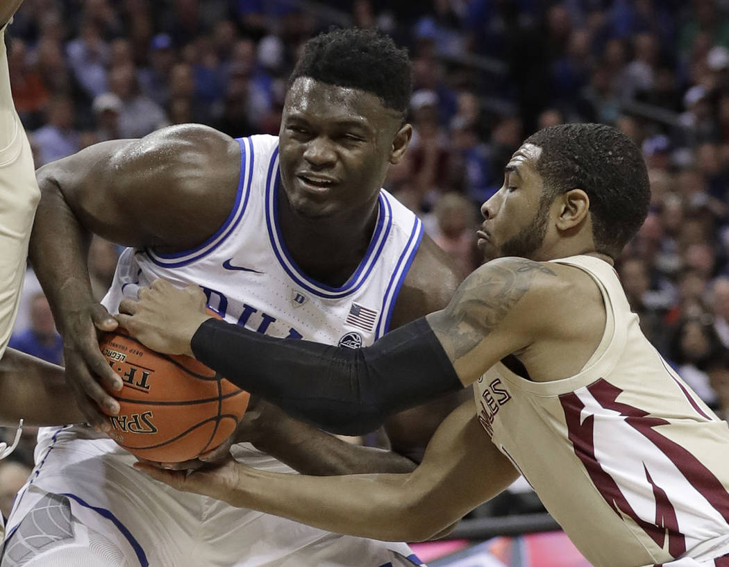 Florida State's David Nichols, right, steals the ball from Zion Williamson, left, during the first half of the NCAA college basketball championship game of the Atlantic Coast Conference tournament ...