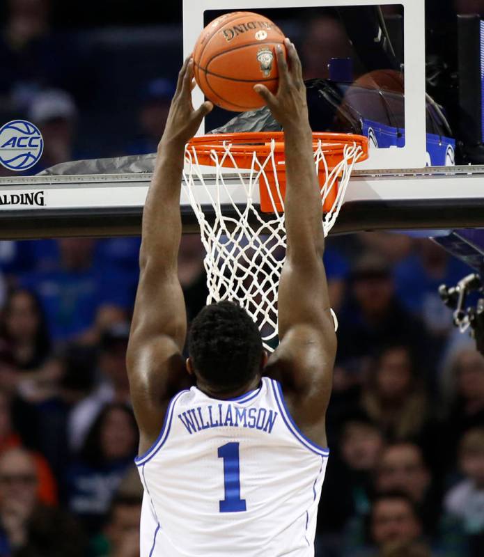 Zion Williamson (1) goes up to dunk against Florida State during the first half of the NCAA college basketball championship game of the Atlantic Coast Conference tournament in Charlotte, N.C., Sat ...
