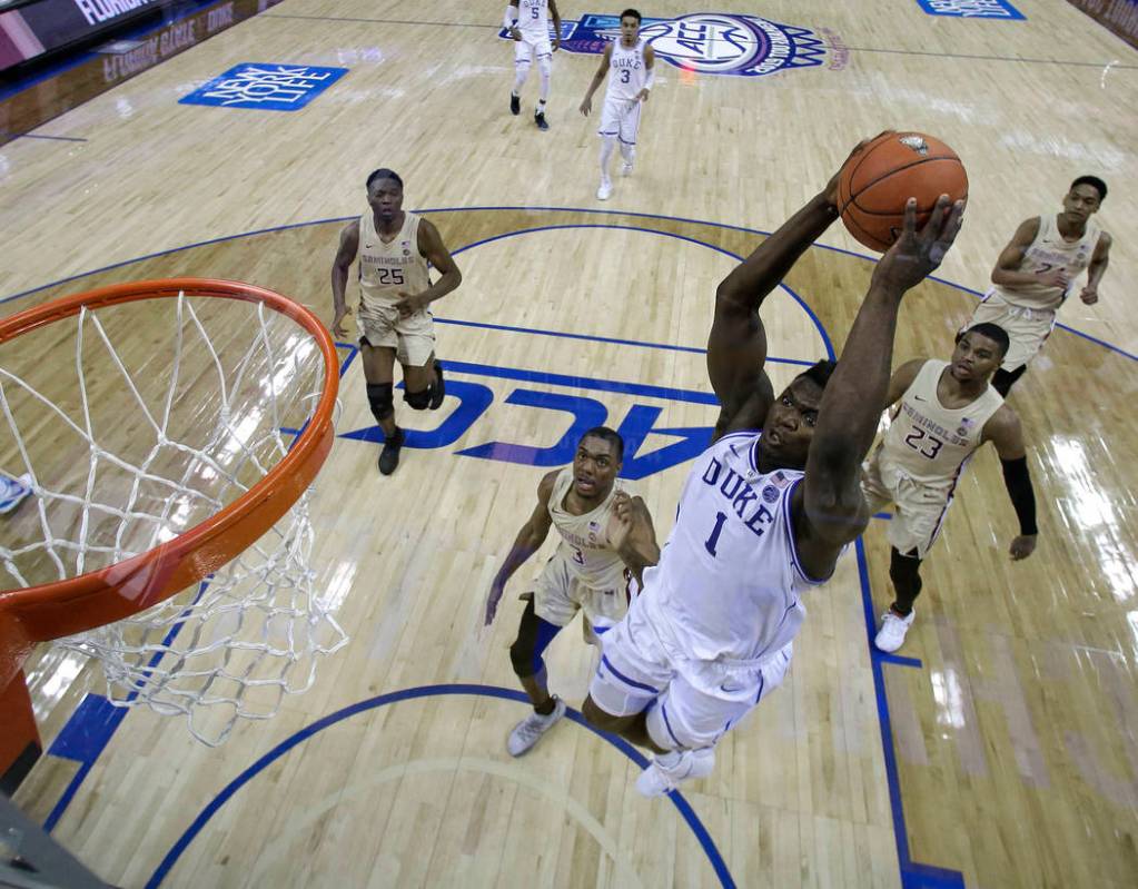 Duke's Zion Williamson (1) goes up to dunk against Florida State during the first half of the NCAA college basketball championship game of the Atlantic Coast Conference tournament in Charlotte, N. ...