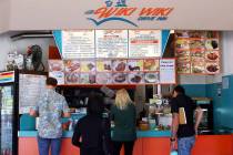 In this Thursday, March 14, 2019 photo, customers line up at the Wiki Wiki Drive Inn takeout restaurant counter in Honolulu. Hawaii would be the first state in the nation to ban most plastics used ...