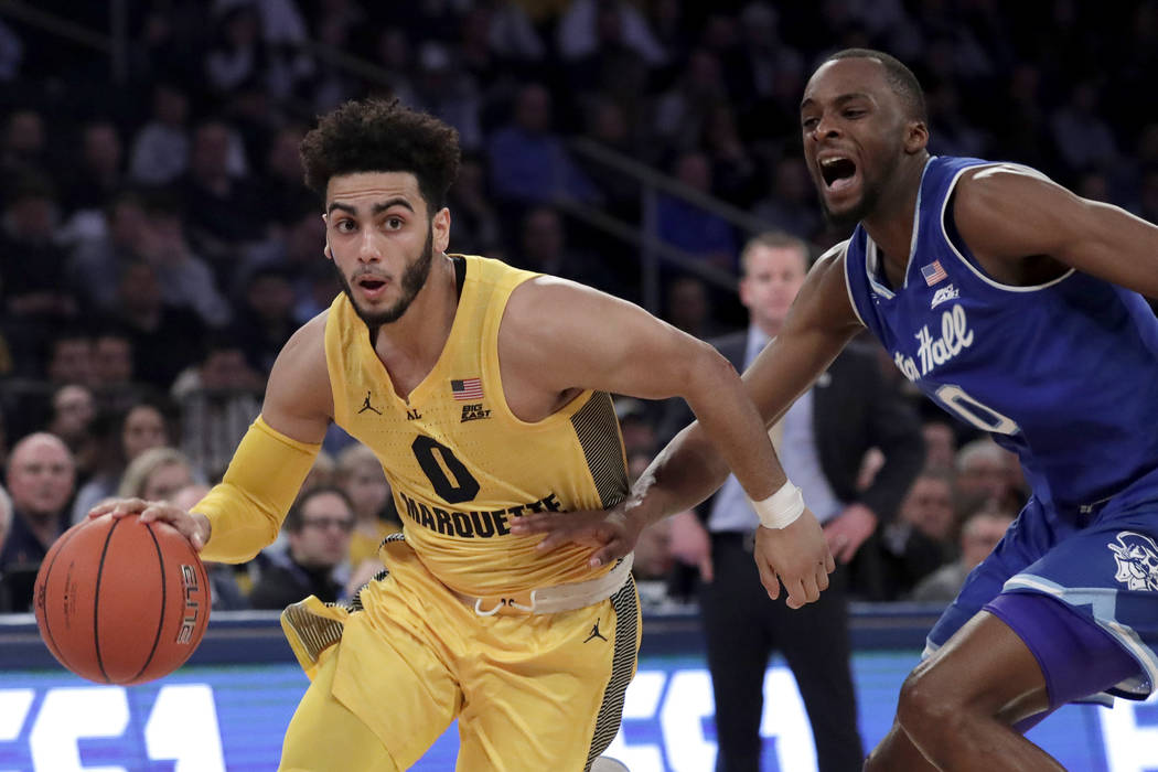Marquette guard Markus Howard (0) drives against Seton Hall guard Quincy McKnight (0) during the first half of an NCAA college basketball semifinal game in the Big East men's tournament, Friday, M ...