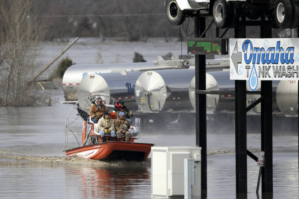 Gabe Schmidt, owner of Liquid Trucking, top right, travels by air boat with Glenn Wyles, top left, Mitch Snyder, bottom left, and Juan Jacobo, bottom right, as they survey damage from the flood wa ...