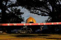 A police officer stands guard in front of the Masjid Al Noor mosque in Christchurch, New Zealand, Sunday, March 17, 2019, where one of two mass shootings occurred. New Zealand's stricken residents ...