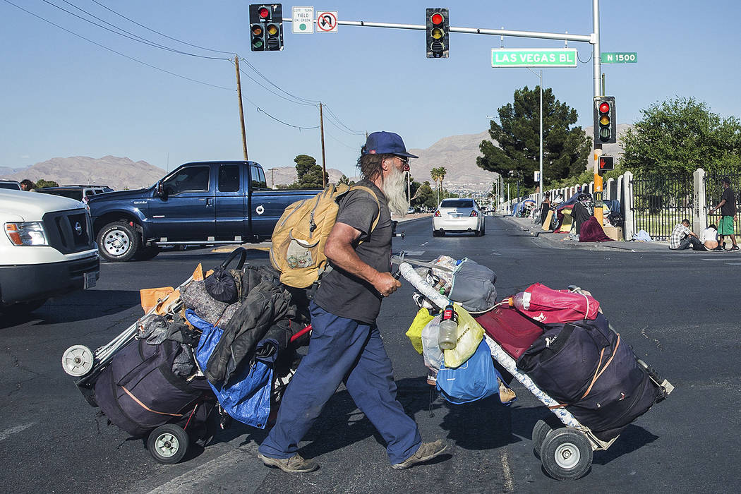 A man carries his possessions across North Las Vegas Boulevard and East Owens Avenue on Thursday, May 3, 2018, in Las Vegas. Benjamin Hager Las Vegas Review-Journal @benjaminhphoto