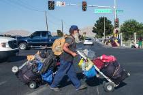 A man carries his possessions across North Las Vegas Boulevard and East Owens Avenue on Thursday, May 3, 2018, in Las Vegas. Benjamin Hager Las Vegas Review-Journal @benjaminhphoto