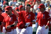 Los Angeles Angels' Mike Trout, center, is congratulated on his three-run home run against the Chicago Cubs in the third inning of a spring training baseball game Tuesday, March 5, 2019, in Tempe, ...