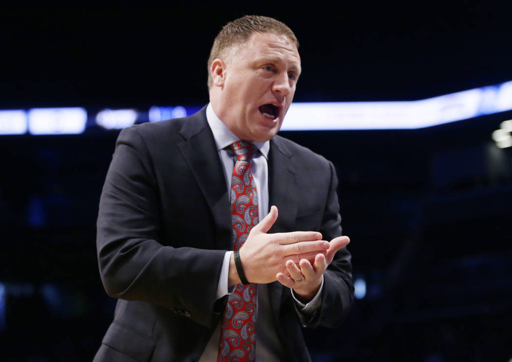 Virginia Commonwealth head coach Mike Rhoades talks to his team during the first half of an NCAA college basketball game against the St. John's in the championship round of the Legends Classic tou ...