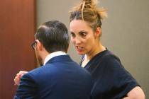 Attorney Alexis Plunkett speaks to her lawyer, Adam Solinger, at the Regional Justice Center in Las Vegas on Tuesday, March 19, 2019. She pleaded guilty to allowing clients to use cellphones in ja ...