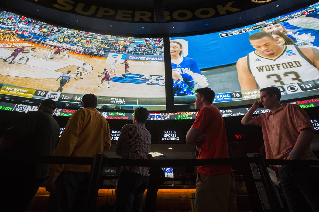 Basketball fans take in the first day of the NCAA Tournament at the Westgate Sportsbook on Thursday, March 21, 2019, at Westgate, in Las Vegas. (Benjamin Hager Review-Journal) @BenjaminHphoto