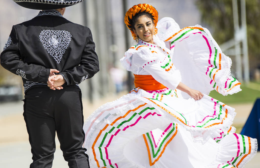 Shadaie Martinez, 17, of the Mexico Vivo dance company, right, performs with Gilberto Rodriguez, 14, during the Cesar Chavez Day festival at Freedom Park in Las Vegas on Saturday, March 23, 2019. ...