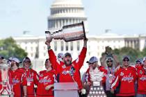 Washington Capitals' Alex Ovechkin holds up the Stanley Cup trophy during the team's Stanley Cup victory celebration at the National Mall in Washington on June 12, 2018. (AP Photo/Jacquelyn Martin ...