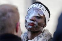 Therese Okoumou poses for pictures and rallies with supporters before her sentencing in New York, Tuesday, March 19, 2019. Okoumou was convicted of trespassing and other offenses after she climbed ...