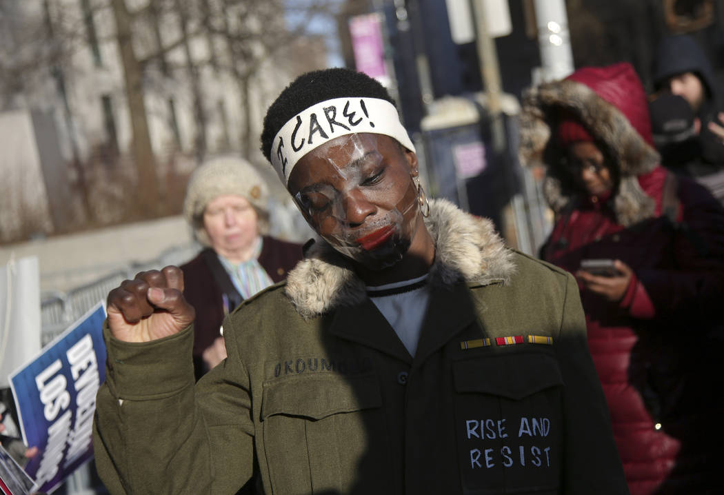 Therese Okoumou poses for pictures and rallies with supporters before her sentencing in New York, Tuesday, March 19, 2019. Okoumou was convicted of trespassing and other offenses after she climbed ...