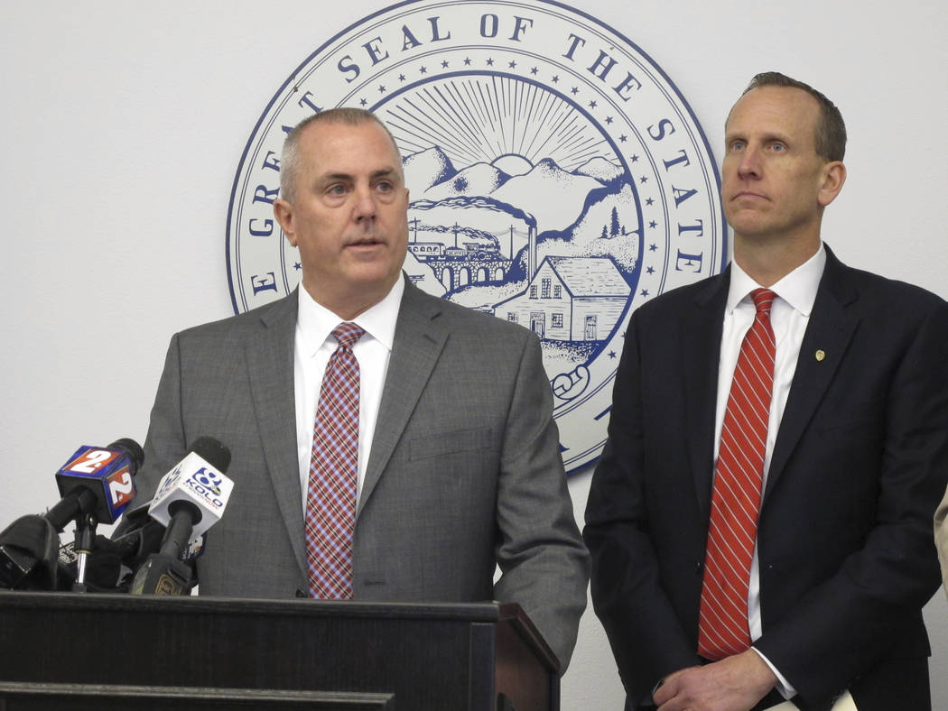 Douglas County District Attorney Mark Jackson answers a reporter's question as Washoe County District Attorney Chris Hicks, right, looks on at a news conference Thursday, March, 14, 2019 in Reno, ...