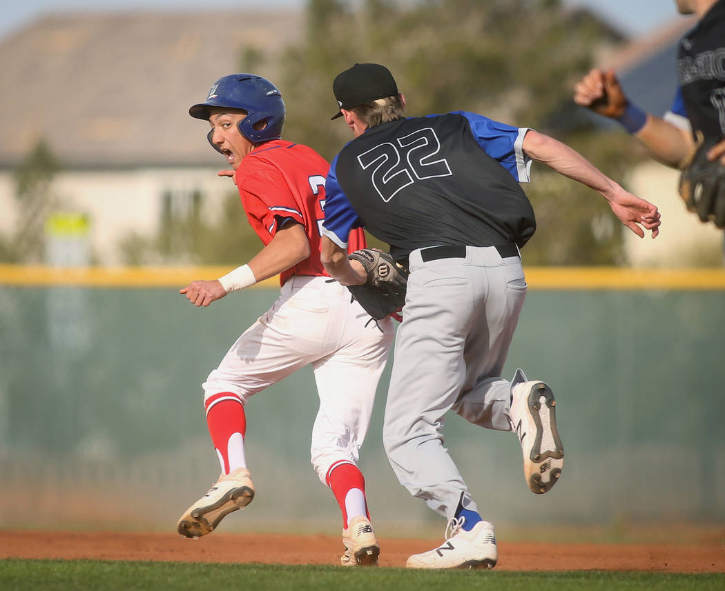 Liberty's Dylan San Nicolas (3) runs away as Basic's Shane Spencer (22) tries to get him out in the fourth inning of a baseball game at Liberty High School in Henderson, Tuesday, March 19, 2019. ( ...