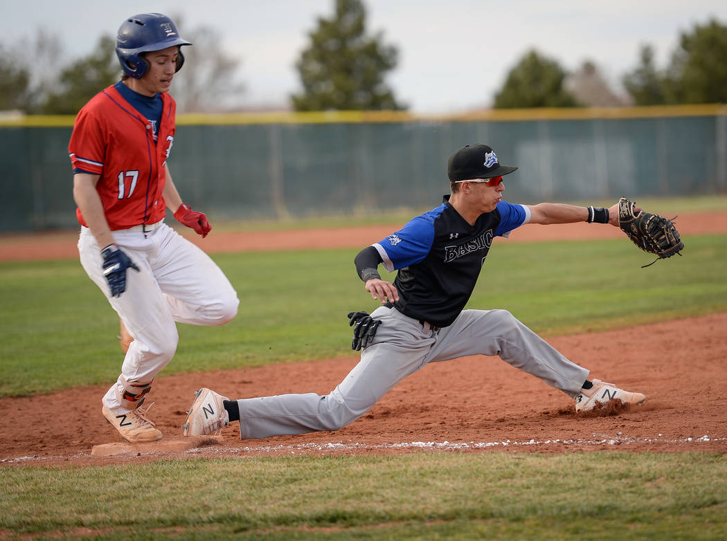 Basic's John Howard Bobo (99) catches the ball getting out Liberty's Ethan Safier (17) in the seventh inning of a baseball game at Liberty High School in Henderson, Tuesday, March 19, 2019. (Carol ...