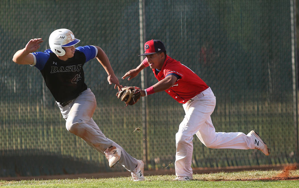 Liberty's Zanden Shim (10) chases after Basic's Zach Hose (44) in an attempt to get him out in the fourth inning of a baseball game at Liberty High School in Henderson, Tuesday, March 19, 2019. (C ...