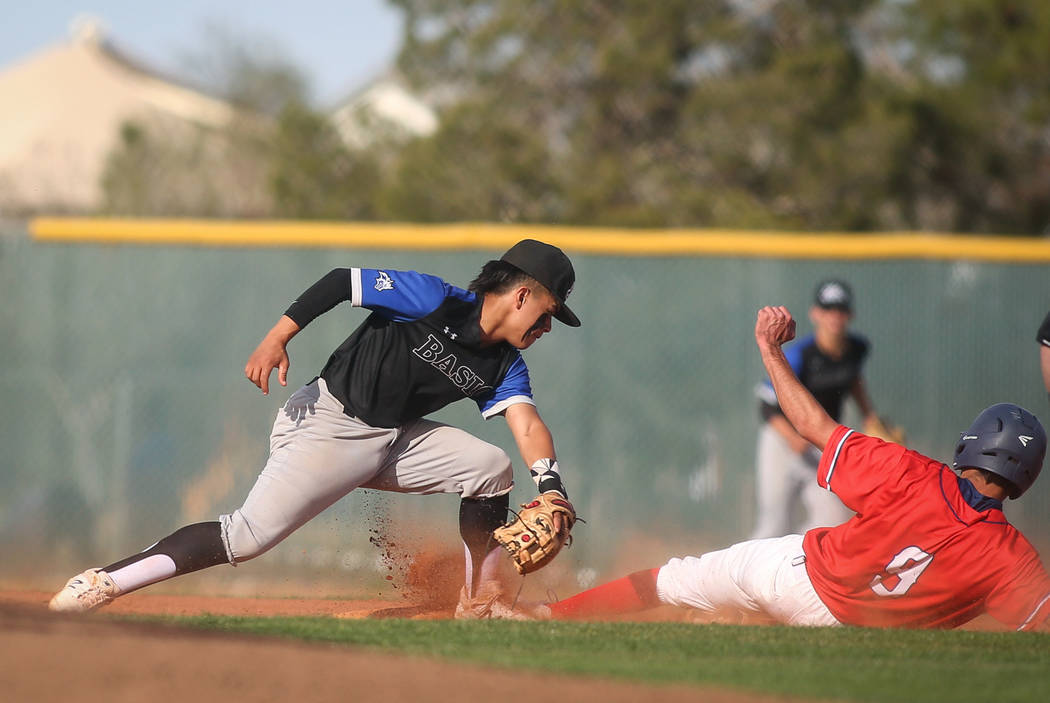 Basic's Dominik Tavares (5) catches a ground ball to get out Liberty's Logan Coons (9) in the fourth inning of a baseball game at Liberty High School in Henderson, Tuesday, March 19, 2019. (Caroli ...