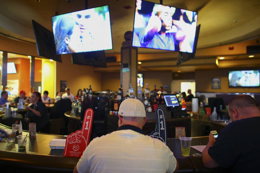 Basketball fans gather around a bar at the Westgate sports book during the first day of the NCAA basketball tournament in Las Vegas on Thursday, March 16, 2017. (Chase Stevens/Las Vegas Review-Jou ...