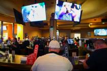 Basketball fans gather around a bar at the Westgate sports book during the first day of the NCAA basketball tournament in Las Vegas on Thursday, March 16, 2017. (Chase Stevens/Las Vegas Review-Jou ...