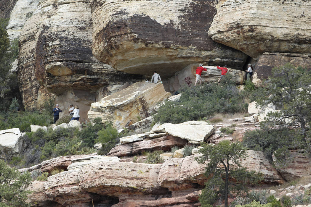 Archaeologists and volunteers work Thursday, May 19, 2011, to restore an ancient rock art site in Red Rock Canyon National Conservation Area that was damaged by graffiti vandals in November. (K.M. ...