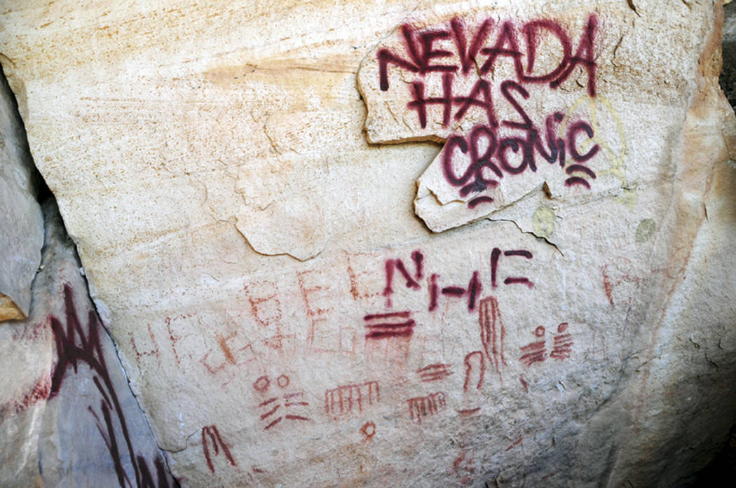 Maroon graffiti defaces stone in the Red Rock Canyon National Conservation Area in November 2010. A tagger gang allegedly vandalized the site painting rocks and in some cases painting on or near a ...