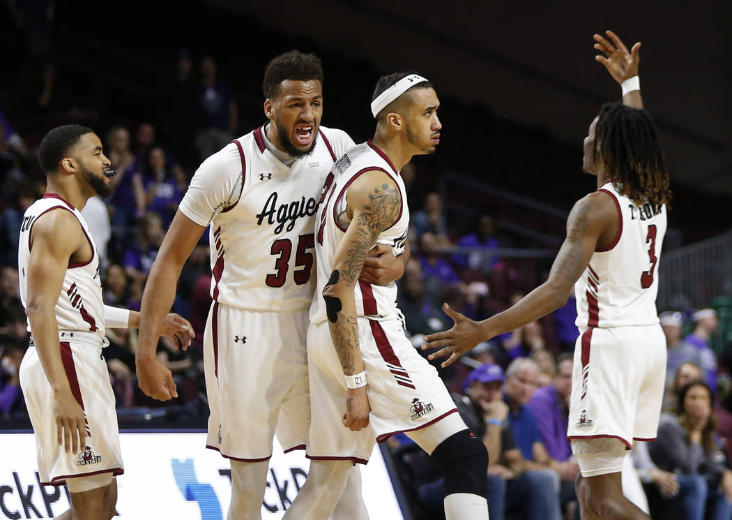 New Mexico State players, from left, Shunn Buchanan, Johnny McCants, Trevelin Queen and Terrell Brown (3) celebrate a basket by Queen during an NCAA college basketball game against Grand Canyon fo ...