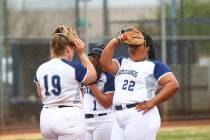 Shadow Ridge's Sydney Morgan (19), Kyanna Galvan (1) and Alyssa Stanley (22) cover their faces as their softball game against Centennial is delayed due to rain at Shadow Ridge High School in Las V ...