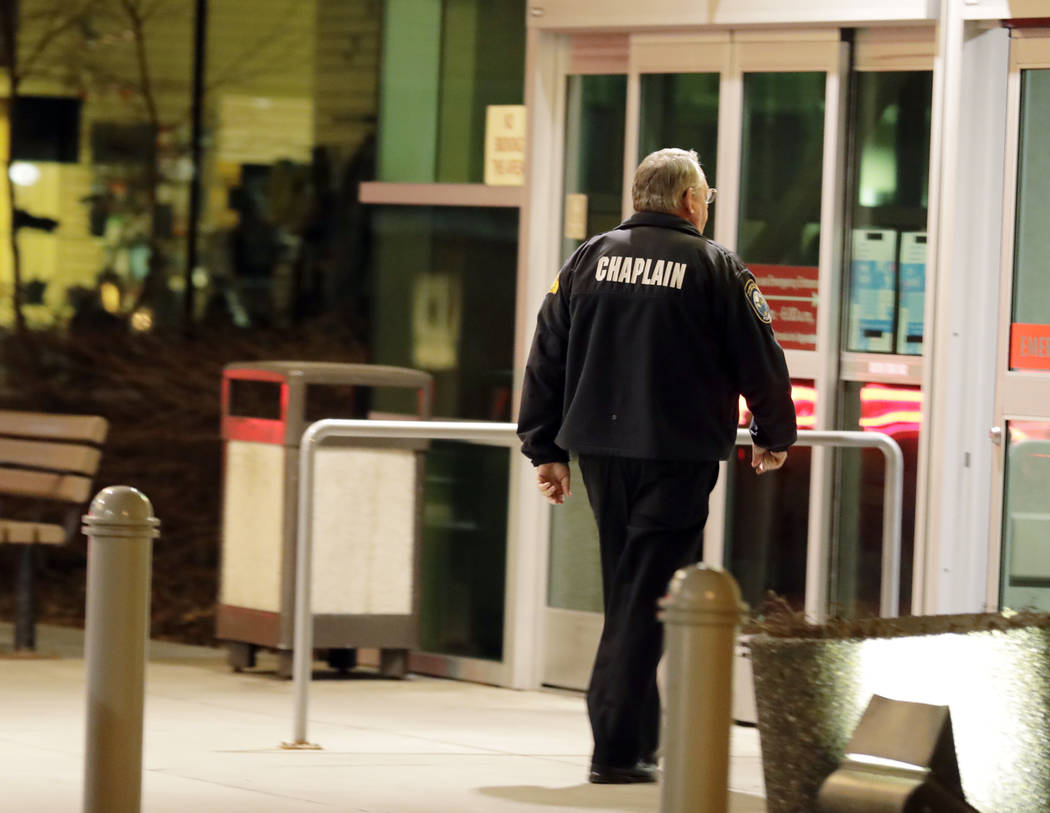 A law enforcement chaplain walks into Kittitas Valley Healthcare Hospital, in the late night hours of Tuesday, March 19, 2019, in Ellensburg, Wash., prior to a procession to accompany the body of ...