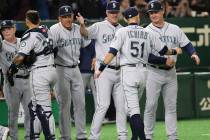 Seattle Mariners right fielder Ichiro Suzuki (51) celebrates with teammates after defeating the Oakland Athletics 9-7 in Game 1 of their Major League opening series baseball game at Tokyo Dome in ...