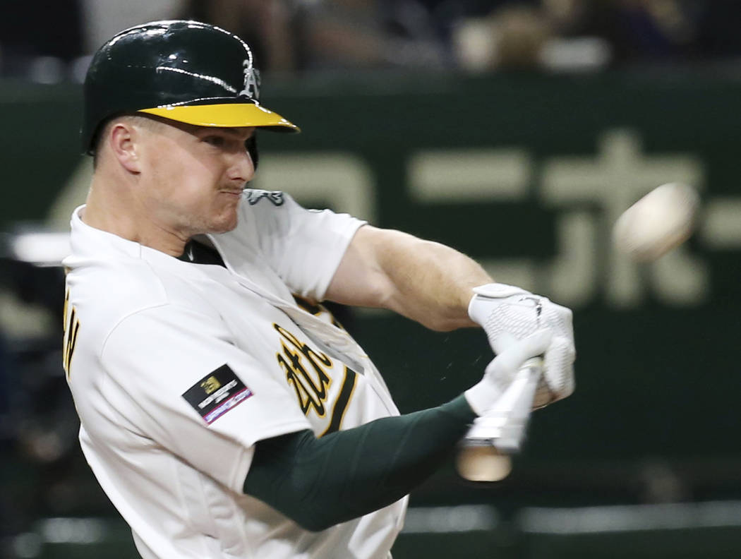 Oakland Athletics's Matt Chapman hits a three-run home run off Seattle Mariners pitcher Nick Rumbelow in the seventh inning of Game 1 of their Major League opening series baseball game at Tokyo Do ...