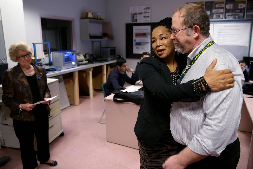 Advanced Technologies Academy teacher Richard Knoeppel, the Nevada Teacher of the Year, gets a hug from Nevada State Board of Education member Tonia Holmes-Sutton as he is told that he will be ind ...
