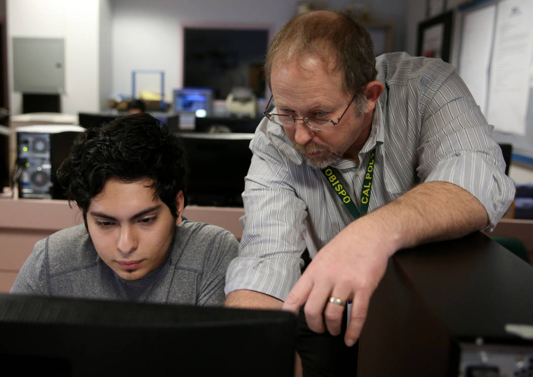 Advanced Technologies Academy teacher Richard Knoeppel, the Nevada Teacher of the Year, works with senior Edin Sosa at his Las Vegas school Wednesday, March 20, 2019. (K.M. Cannon/Las Vegas Review ...