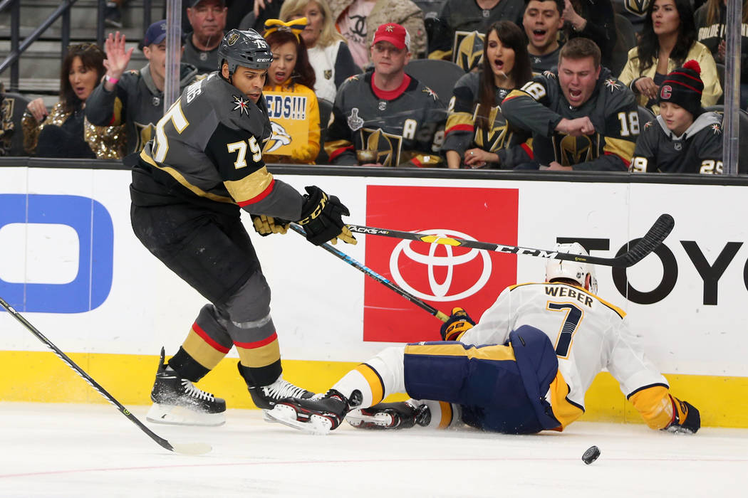 Vegas Golden Knights right wing Ryan Reaves (75) knocks down Nashville Predators defenseman Yannick Weber (7) during the first period of an NHL hockey game at T-Mobile Arena in Las Vegas, Saturday ...