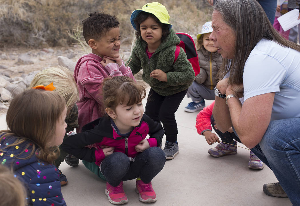 Naturalist Jody Walker shows Alina Velaochaga, 4, from left, Asante Ricigliano-Vaughn, 5, and Louie Schmidt, 3, how to pretend to be a baby owl during the Nature Tykes program at Clark County Wetl ...