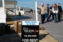 FILE- In this March 8, 2014 file photo people walk past a home being offered as a summer rental on the boardwalk in Point Pleasant Beach N.J. New Jersey shore property owners and renters worry tha ...