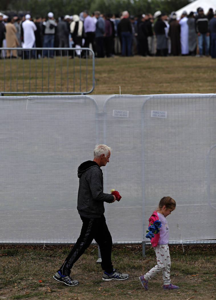 Mourners leave the cemetery after the burial service for a victim of the Friday March 15 mosque shootings at the Memorial Park Cemetery in Christchurch, New Zealand, Thursday, March 21, 2019. (AP ...