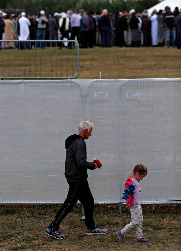 Mourners leave the cemetery after the burial service for a victim of the Friday March 15 mosque shootings at the Memorial Park Cemetery in Christchurch, New Zealand, Thursday, March 21, 2019. (AP ...