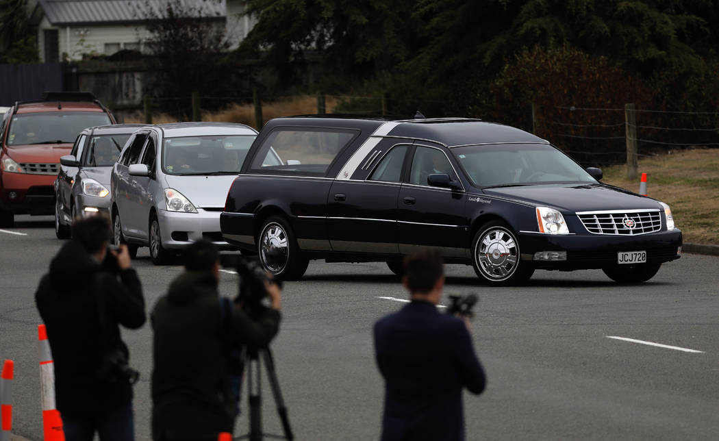 A hearse arrives with the body of a victim of the mosque shootings for burial at the Memorial Park Cemetery in Christchurch, New Zealand, Thursday, March 21, 2019. (AP Photo/Vincent Yu)