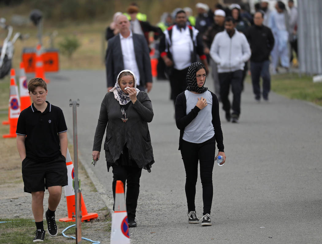 Mourners leave the cemetery after the burial service of a victim of the Friday March 15 mosque shootings at the Memorial Park Cemetery in Christchurch, New Zealand, Thursday, March 21, 2019. (AP P ...