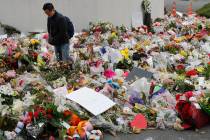 Mourners lay flowers near the Al Noor mosque in Christchurch, New Zealand, Thursday, March 21, 2019. (AP Photo/Vincent Thian)