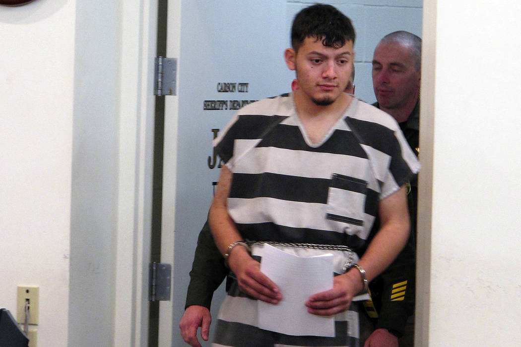 Wilber Ernesto Martinez-Guzman, 19, of El Salvador, is escorted into the courtroom for his initial appearance in Carson City Justice Court in Carson City, Nev. on Jan. 24, 2019. A grand jury has i ...
