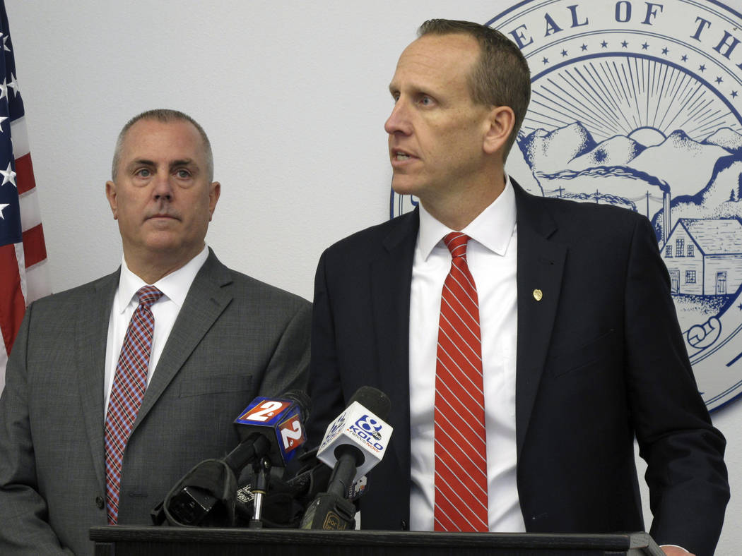 Washoe County District Attorney Chris Hicks, right, announces they will seek the death penalty for a Salvadoran immigrant accused of murdering four northern Nevadans during a week-long killing spr ...