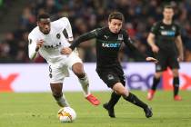 Valencia's Geoffrey Kondogbia, left, and Krasnodar's Mauricio Pereyra challenge for the ball during the Europa League round of 16, second leg soccer match between FC Krasnodar and Valencia at the ...