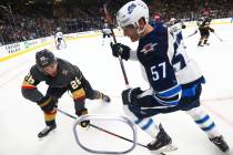 Golden Knights center Paul Stastny (26) and Winnipeg Jets defenseman Tyler Myers (57) battle for the puck during the second period of an NHL hockey game at T-Mobile Arena in Las Vegas on Friday, F ...