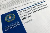 FILE - In this Nov. 17, 2017, file photo, the cover page of a FBI report on the rise of black "extremists" is photographed in Washington. The report is stirring fears of a return to prac ...