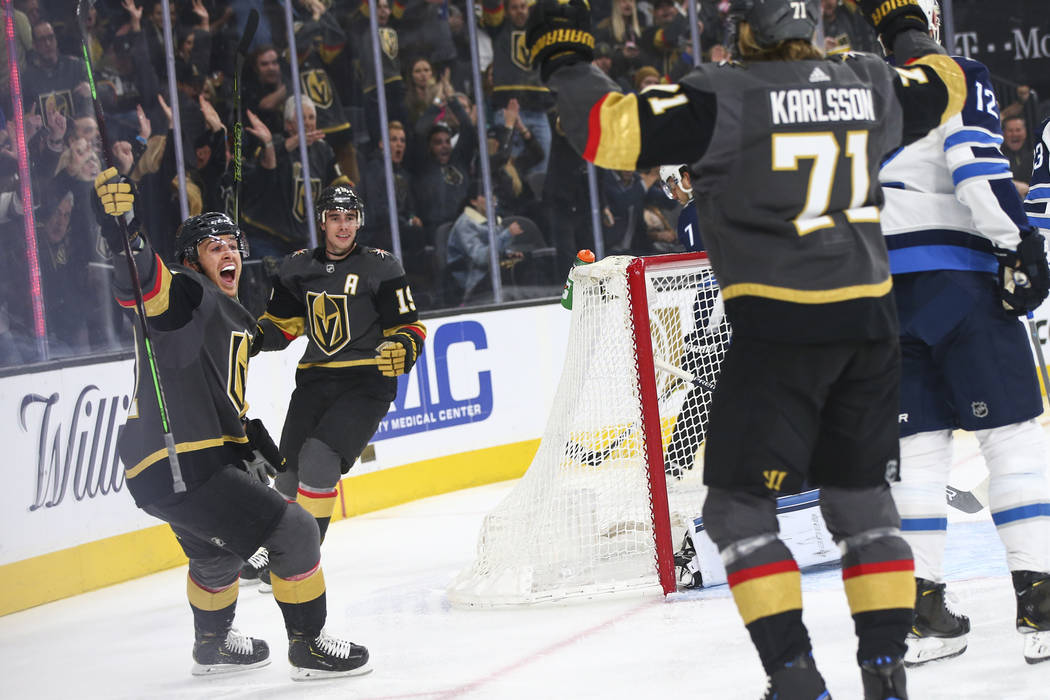 Golden Knights center Jonathan Marchessault, left, celebrates a goal by Golden Knights center William Karlsson (71) as Golden Knights right wing Reilly Smith (19) looks on during the first period ...