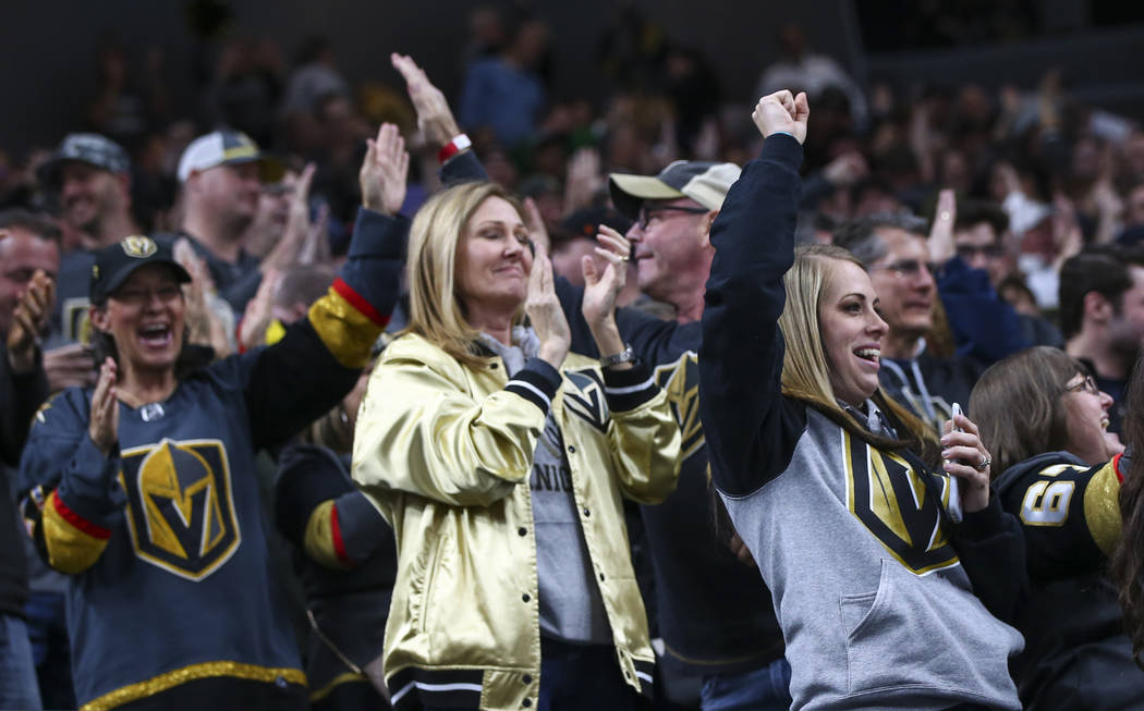 Golden Knights fans celebrate a goal by Golden Knights center William Karlsson, not pictured, during the first period of an NHL hockey game against the Winnipeg Jets at T-Mobile Arena in Las Vegas ...